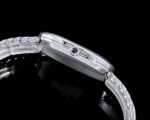 Green dial 5738 watch with silver-tone chain-link bracelet - crown and case detail